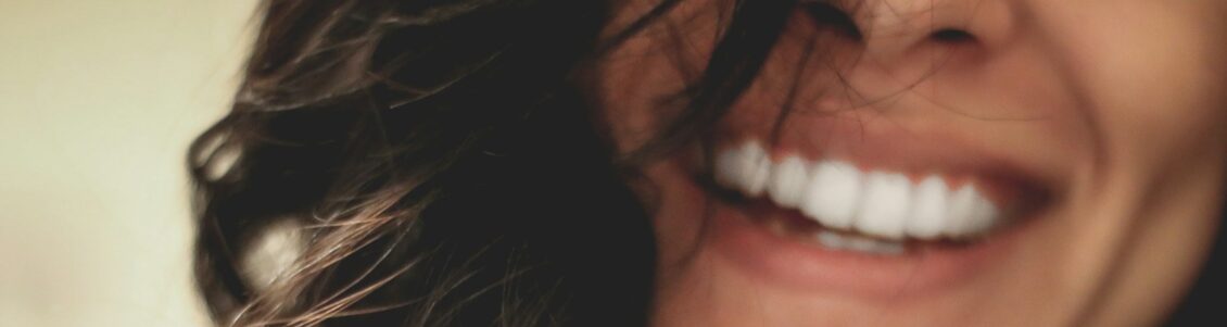Photo by Lesly Juarez long black haired woman smiling close-up photography