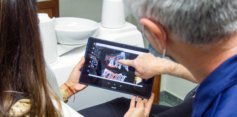 woman in blue denim jeans holding black tablet computer